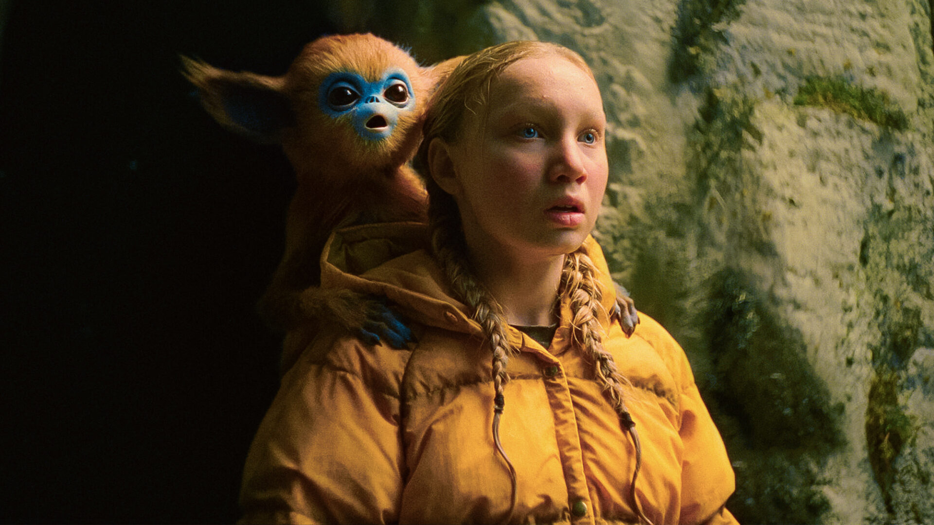 Girl and a creature. Scene from a film. Person in a spacesuite. Photo/image: ‘The Legend of Ochi’ courtesy of A24